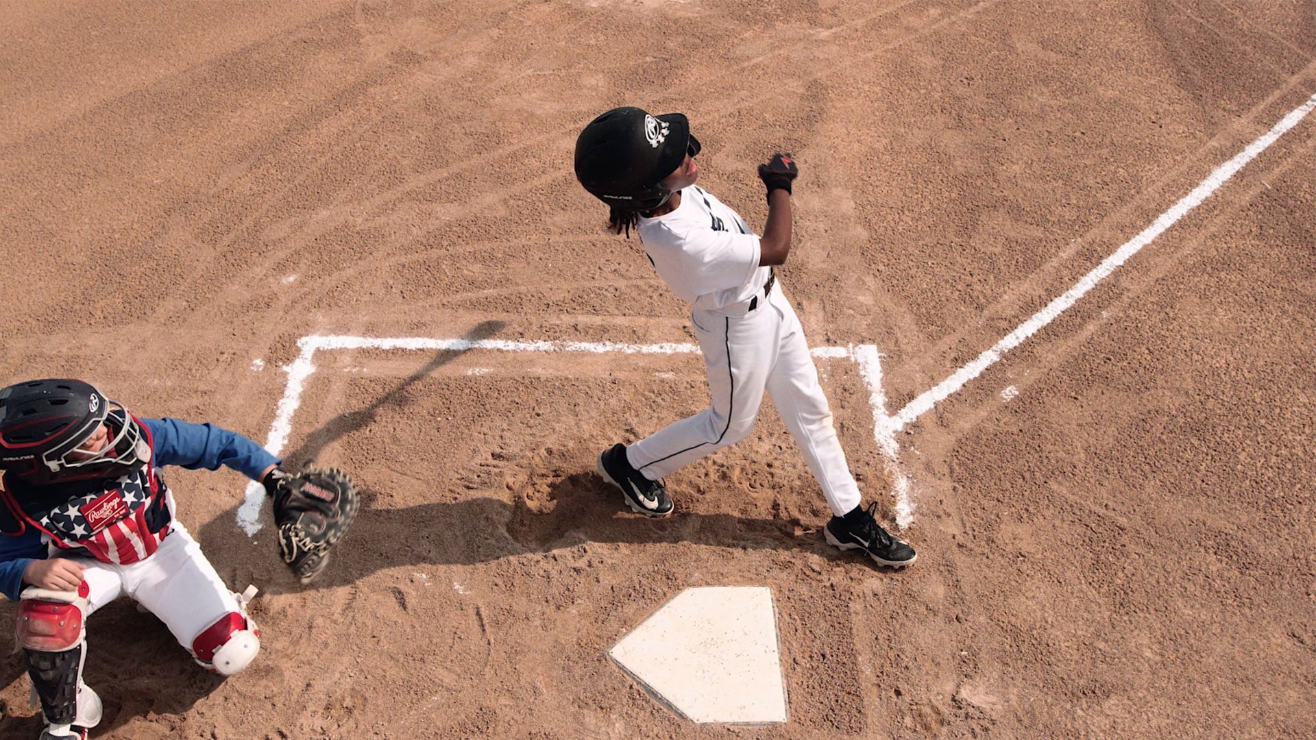 tween child playing baseball
