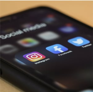 A smart phone with social media apps on the screen.