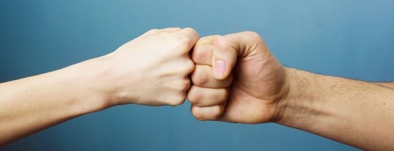 Two fists in a fist bump.