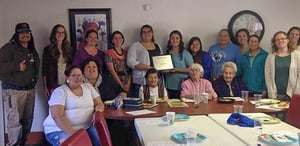 A group of Native American people gathering to celebrate a non-smoking policy.